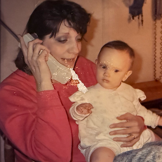 a tinier, babier female-shaped creature sits on its mother's lap and listens into her phone conversation